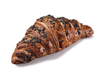 A picture of a baked croissant covered with chocolate chips